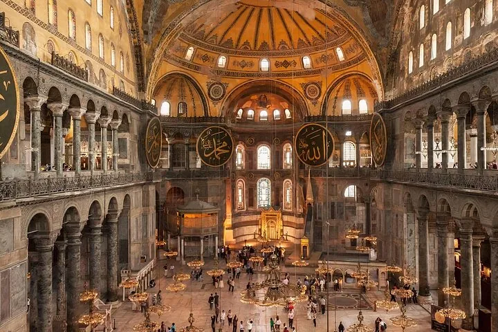 Vast interior of Hagia Sophia with its massive dome and Islamic calligraphy medallions